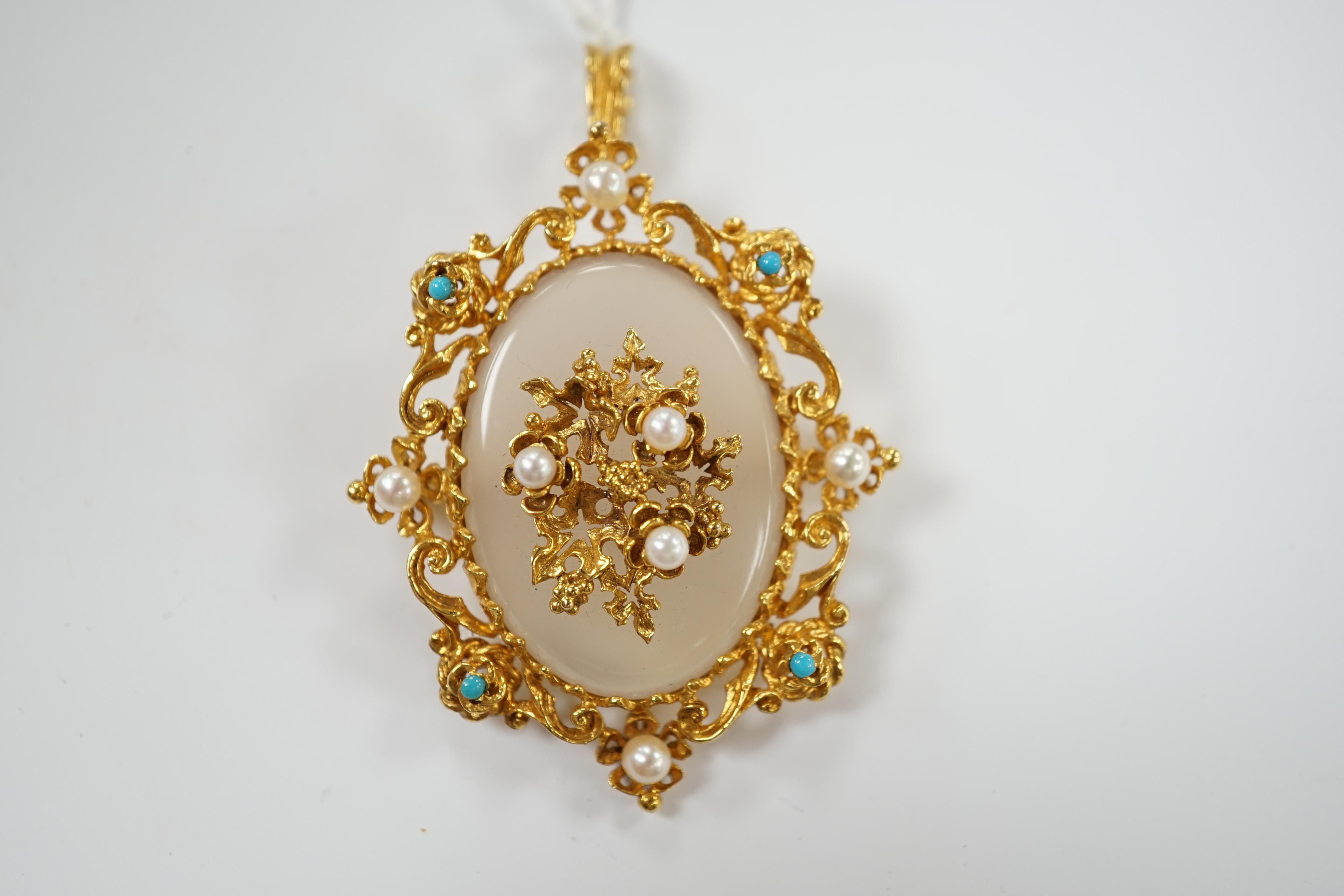 A 1970's Victorian style 9ct gold, white chalcedony, turquoise and seed pearl set pendant brooch, overall 59mm, gross weight 16.8 grams.